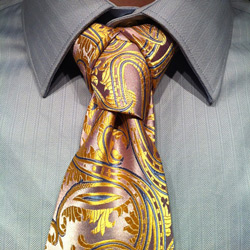 cape knot on paisly pink and yellow tie