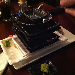 stack of empty plates at a sushi buffet