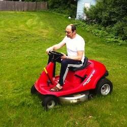 Alex Krasny on a riding lawnmower