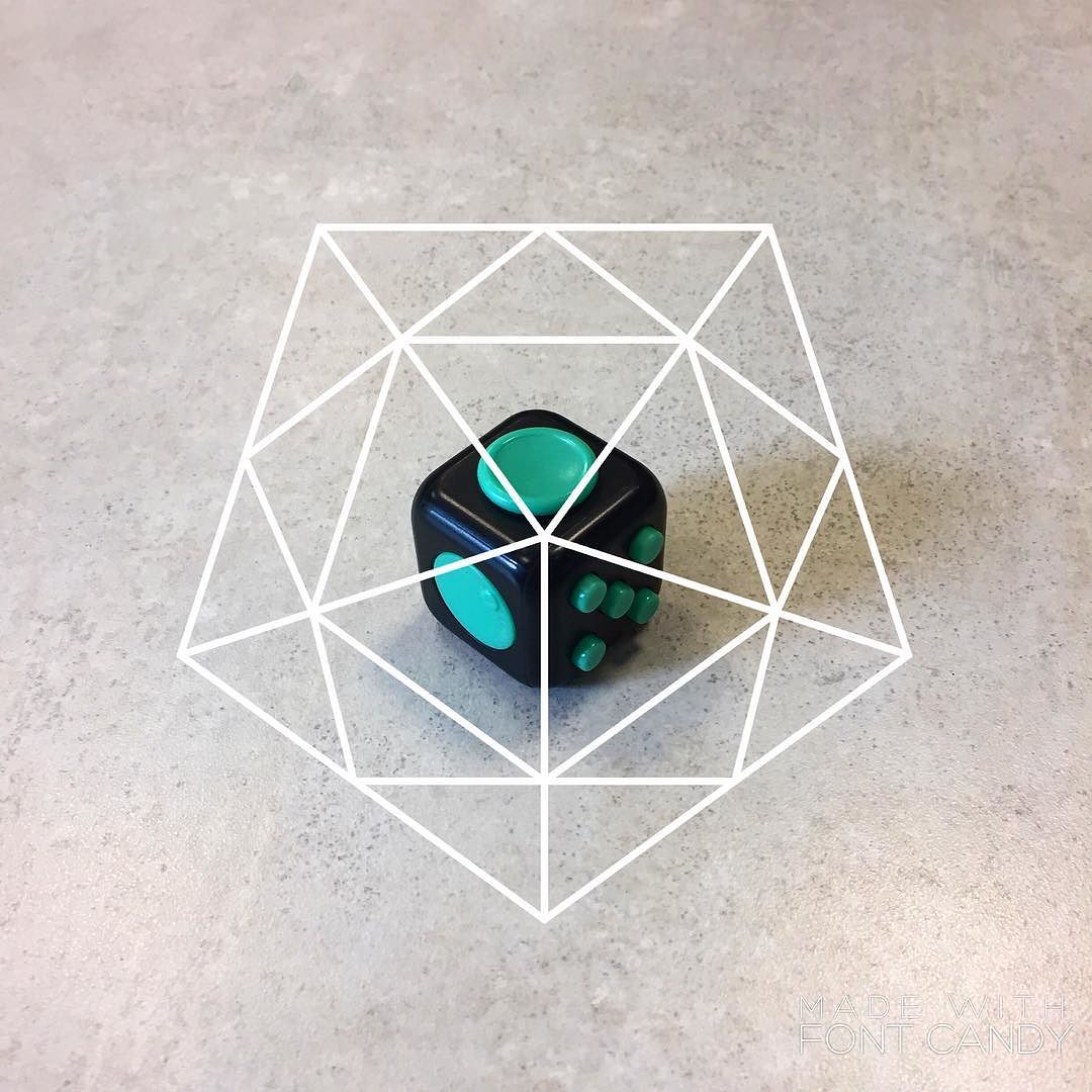 a fidget cube with a geometric shape superimposed over it
